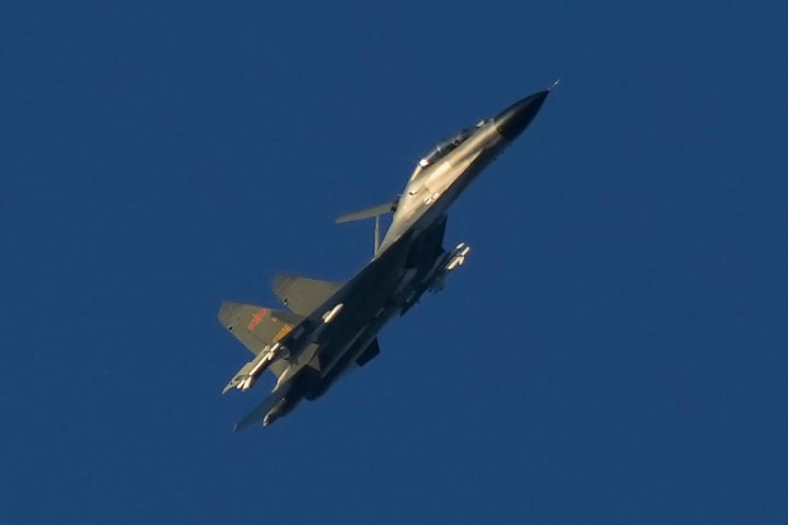A Chinese J-11 military fighter jet flies above the Taiwan Strait.