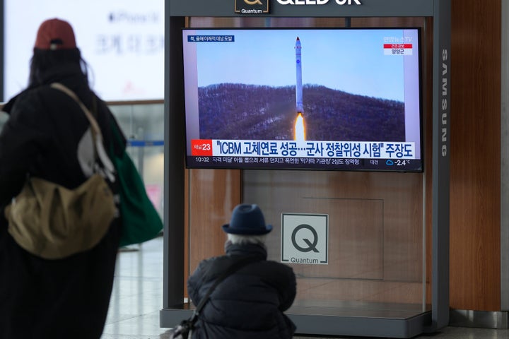 A TV screen shows a file image of North Korea's rocket with the test satellite during a news program at the Seoul Railway Station in South Korea on Saturday.