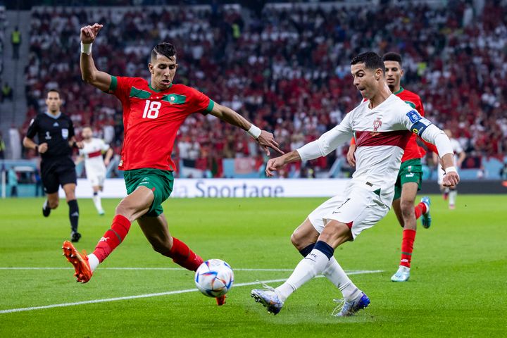 10 December 2022, Qatar, Doha: Soccer: World Cup, Morocco - Portugal, final round, quarterfinals, Al-Thumama Stadium, Portugal's Cristiano Ronaldo (r) in action against Morocco's Jawad El Yamiq (l). Photo: Tom Weller/dpa (Photo by Tom Weller/picture alliance via Getty Images)