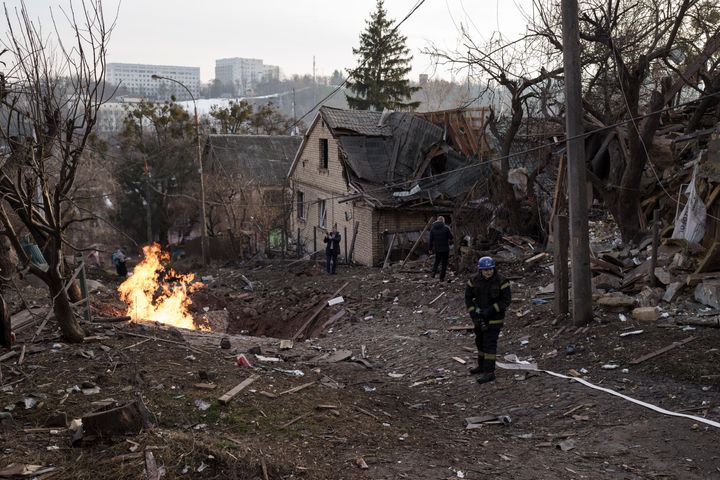 Emergency workers arrive at a residential area hit during a Russian attack in Kyiv, Ukraine, Saturday, Dec. 31, 2022. (AP Photo/Roman Hrytsyna)