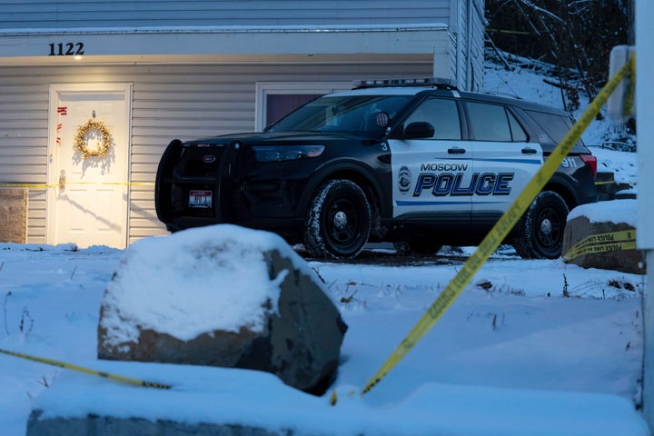 FILE - A Moscow police officer stands guard in his vehicle, Tuesday, Nov. 29, 2022, at the home where four University of Idaho students were found dead Nov. 13, 2022, in Moscow, Idaho. Idaho police investigating the stabbing deaths of the students say they are working with law enforcement in Eugene, Ore., to determine if a white sedan found on the side of the road there is related to the Idaho case. (AP Photo/Ted S. Warren, File)