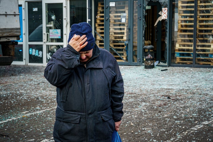 A woman reacts after Russian shelling of the Ukrainian city of Kherson on December 24, 2022. (Photo by DIMITAR DILKOFF/AFP via Getty Images)