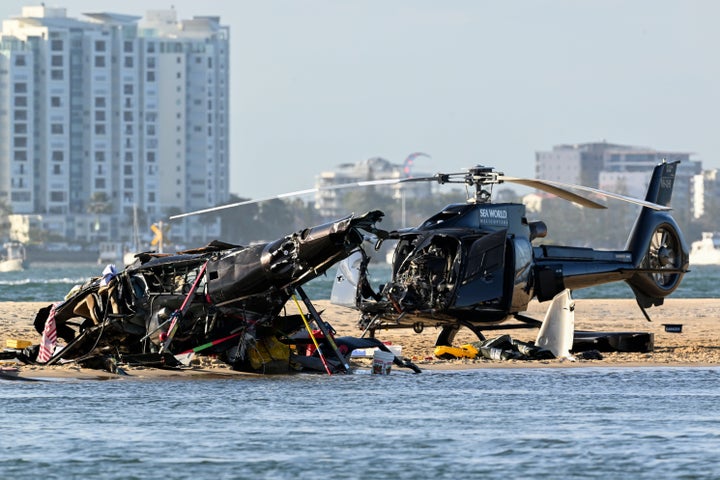Two crashed helicopters sit on the sand at a collision scene near Seaworld, on the Gold Coast, Australia, Monday, Jan. 2, 2023.