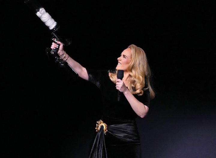 Adele firing a t-shirt gun during the first night of her Weekends With Adele live show