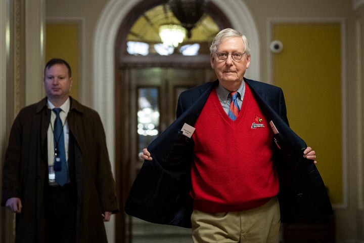 Senate Minority Leader Mitch McConnell (R-Ky.) shows his University of Louisville sweater as he walks from the Senate floor back to his office at the U.S. Capitol on Dec. 22, 2022, in Washington, D.C.