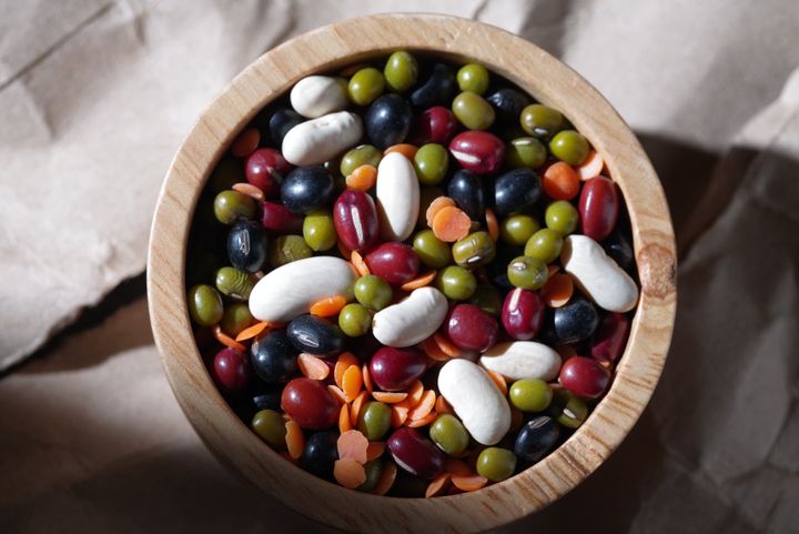 The colorful healthy mixed beans in a wooden container