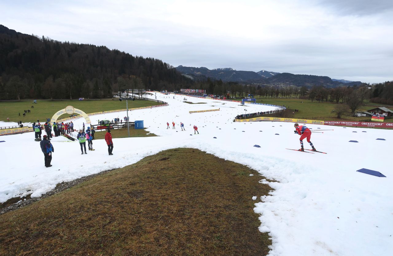 Athletes compete in snowless landscape at the 20 kilometers pursuit competition during the Tour de Ski in Oberstdorf, Germany, Wednesday, Jan. 4, 2023. (Karl-Josef Hildenbrand/dpa via AP)