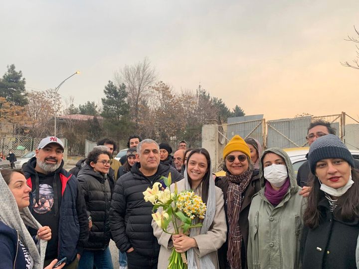 Iranian prominent actress Taraneh Alidoosti, center, holds bunches of flowers as she poses for a photo among her friends after being released from Evin prison in Tehran, Iran, on Jan. 4, 2023. 