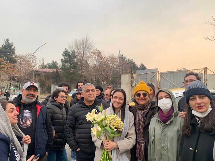 Iranian prominent actress Taraneh Alidoosti, center, holds bunches of flowers as she poses for a photo among her friends after being released from Evin prison in Tehran, Iran, on Jan. 4, 2023.