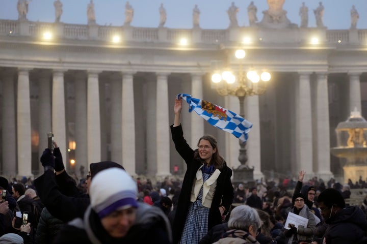 Faithful arrive into St. Peter's Square at the Vatican ahead of the funeral mass for late Pope Emeritus Benedict XVI on Thursday.