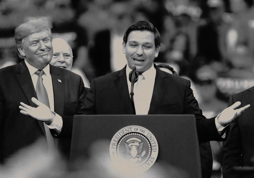 President Donald Trump looks on as Florida Gov. Ron DeSantis (R) speaks during the Florida Homecoming rally at the BB&T Center in Sunrise, Florida, Nov. 26, 2019.