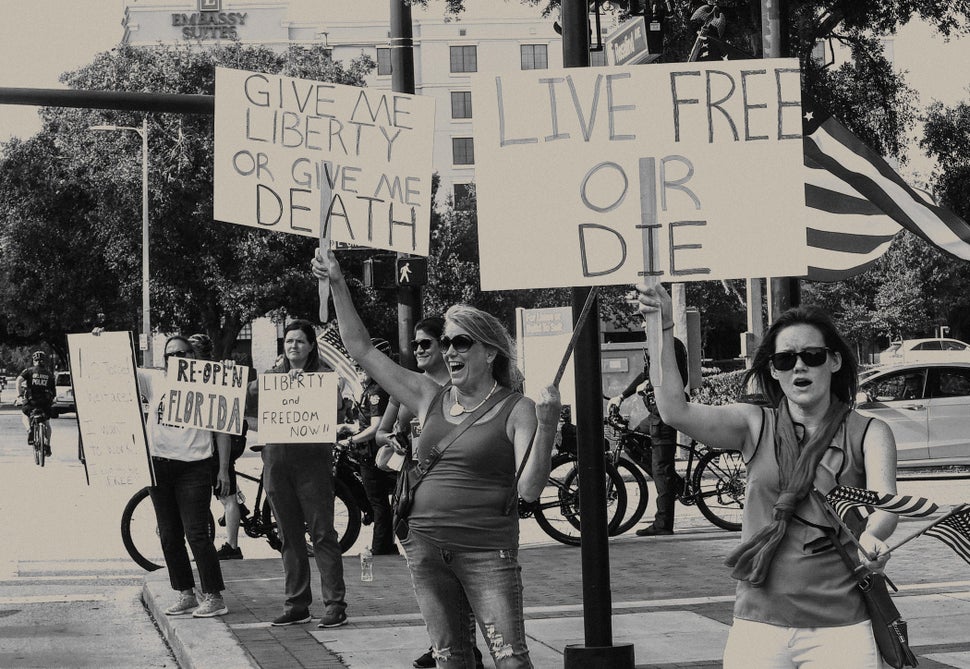 Protesters demonstrate outside the Orange County Administration Building in Orlando, Florida, on April 17, 2020, demanding the end of stay-at-home orders and the reopening of Florida businesses amid the COVID-19 pandemic.