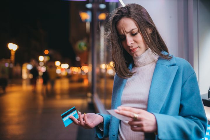 Beautiful woman using ATM machine on the street