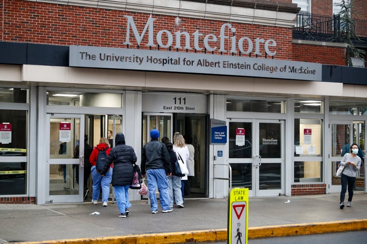 FILE - Medical workers enter Montefiore Medical Center during the coronavirus pandemic, Friday, April 24, 2020, in the Bronx borough of New York. Negotiations to keep 10,000 New York City nurses from walking off the job headed Friday, Jna. 6, 2023, into a final weekend as some major hospitals braced for a potential strike by sending ambulances elsewhere and transferring such patients as vulnerable newborns. (AP Photo/John Minchillo, File)