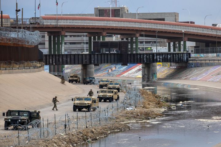 Texas National Guard soldiers stand guard at the U.S.-Mexico border on Saturday as viewed from Ciudad Juarez, Mexico.