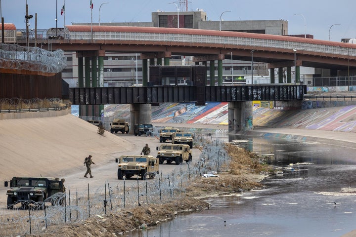 Texas National Guard soldiers stand guard at the U.S.-Mexico border on Saturday as viewed from Ciudad Juarez, Mexico.