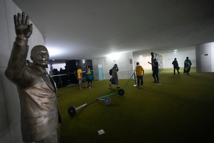 Protesters, supporters of Brazil's former President Jair Bolsonaro, storm the the National Congress building in Brasilia, Brazil, Sunday, Jan. 8, 2023. (AP Photo/Eraldo Peres)