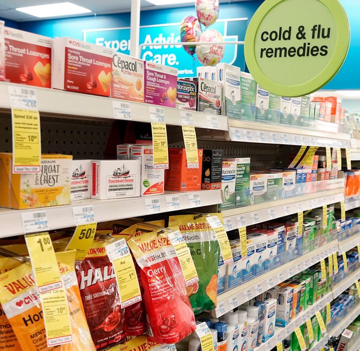 Over-the-counter cold and flu remedies in a pharmacy. Treatments specific to COVID-19 have been approved by the FDA for use, with more expected.