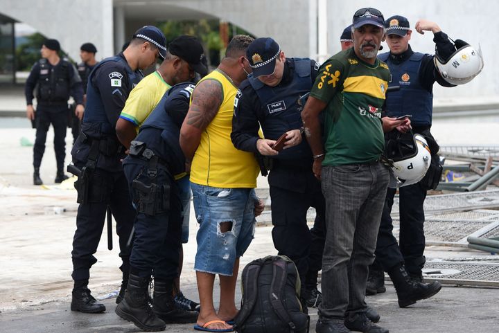 Security forces arrest supporters of Brazilian former President Jair Bolsonaro after retaking control of Planalto Presidential Palace in Brasilia on Jan. 8, 2023