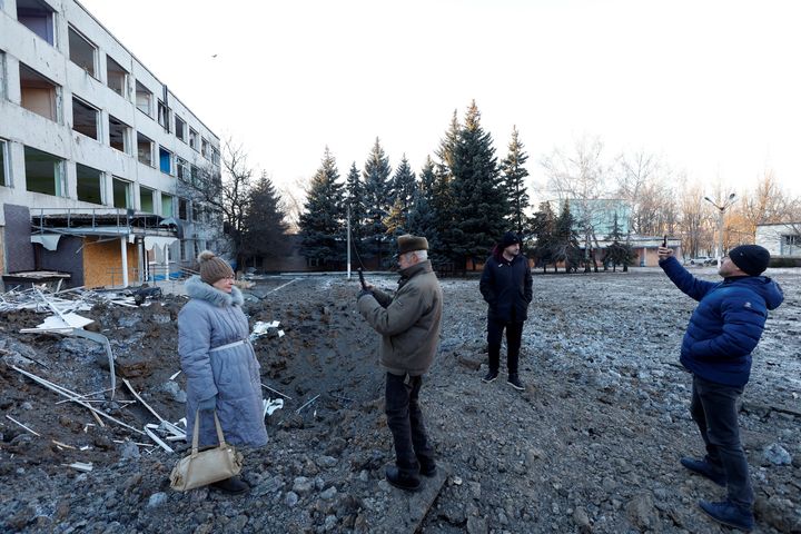 People look at the site of a missile strike that occurred during the night, in Kramatorsk, Ukraine, January 8, 2023. 