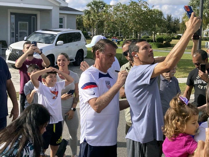 Former Brazil President Jair Bolsonaro, center, meets with supporters outside a vacation home where he is staying near Orlando, Florida., on Wednesday, Jan. 4, 2023.