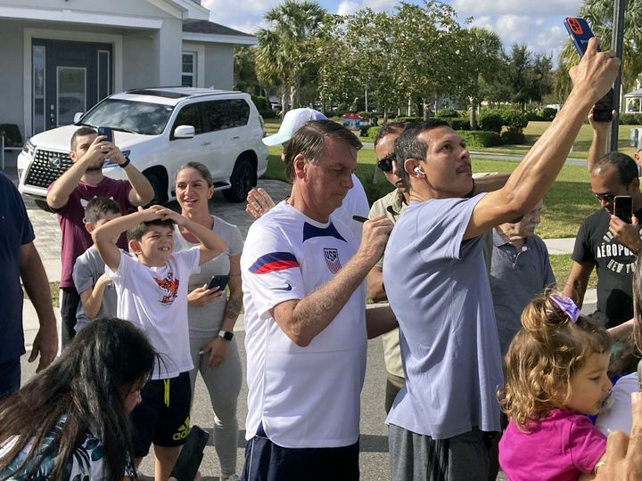Former Brazilian President Jair Bolsonaro, center, meets with supporters outside a vacation home in Orlando, Florida, on Jan. 4.