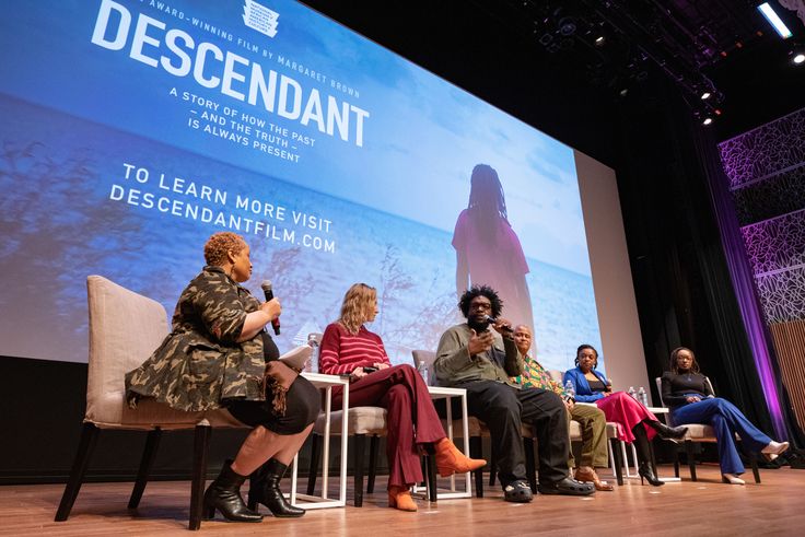 Questlove (center) speaks at a panel discussion of "Descendant" at Smithsonian's National Museum of African American History & Culture.