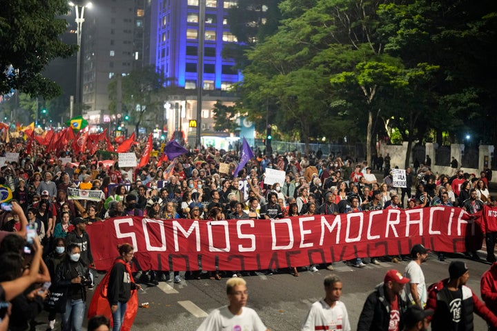Demonstrators march holding a banner that reads in Portuguese "We are Democracy" during a protest calling for protection of the nation's democracy in Sao Paulo, Brazil, on Jan. 9, 2023, a day after supporters of former President Jair Bolsonaro stormed government buildings in the capital.