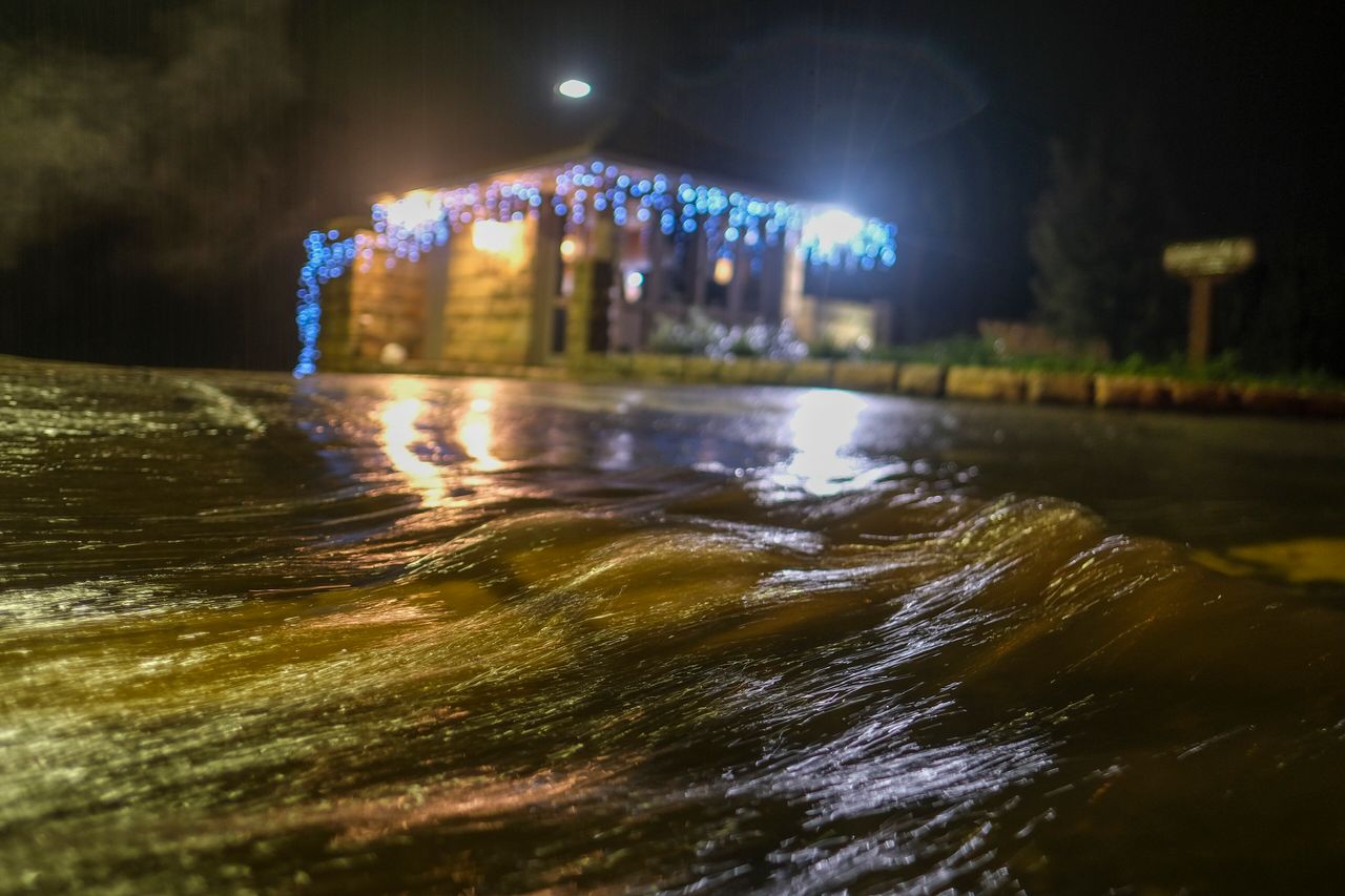 Water runs down a road in Montecito, Calif., Monday, Jan. 9, 2023. (AP Photo/Ringo H.W. Chiu)