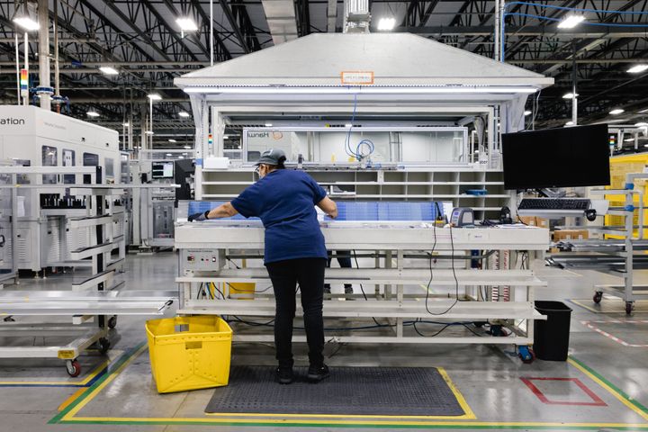 An employee performs quality control on a string of photovoltaic cells on the assembly floor at the Qcells solar panel manufacturing facility in Dalton, Georgia. Unfortunately, China's dominance over solar manufacturing leaves America vulnerable. 