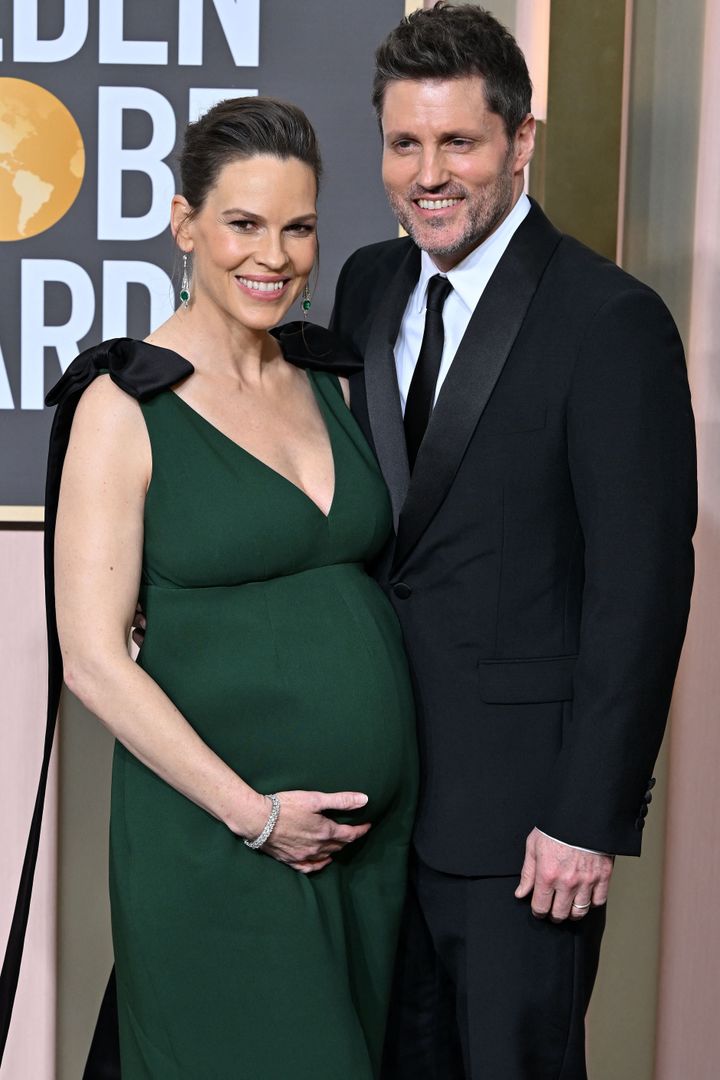 Hilary Swank and Philip Schneider, who are expecting twins, pose on the red carpet at the 80th annual Golden Globe Awards.