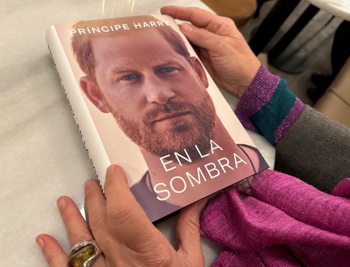 A woman holds a copy of "En La Sombra" (In the Shadow), the Spanish translation of Prince Harry's memoir, in Barcelona, Spain.