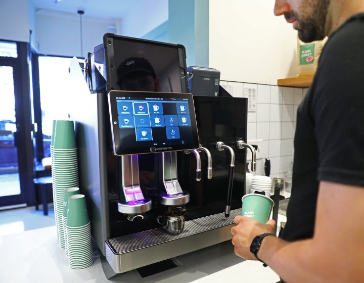 Making a latte at one of Blank Street's locations in Boston. The coffee shop's model of small, minimalist locations means workers are often left to their own devices when problems arise.