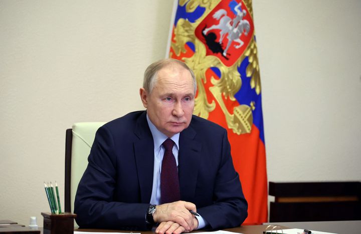 Vladimir Putin chairs a meeting with members of the government via a video conference.