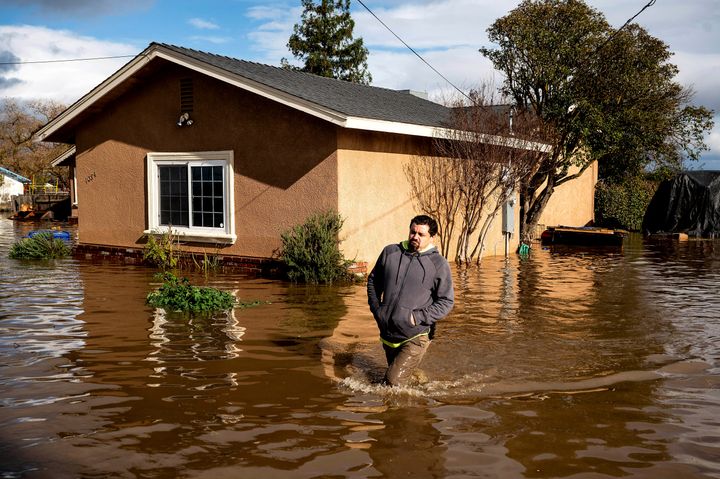 Nick Enero wades through floodwaters while helping his brother salvage items from his Merced, Calif., home as storms continue battering the state on Jan. 10, 2023. The series of storms that have struck California have poured water on a state mired in a years-long drought. Experts say the precipitation will help relieve the drought somewhat.