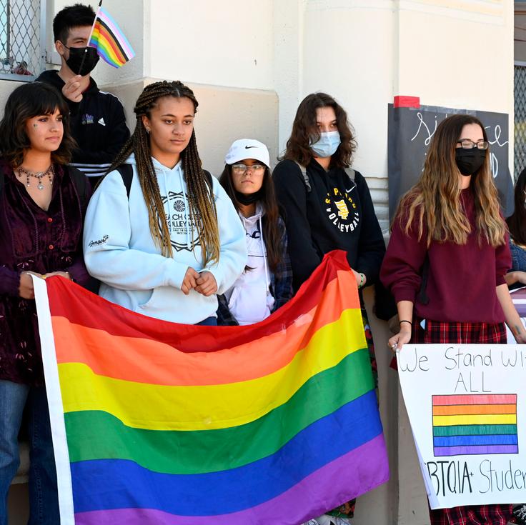 High school students in Los Angeles take part in a rally on April 22 to support LGBTQ people as districts elsewhere in the nation see pride flag bans and other crackdowns.