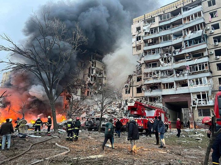 Rescuers and local residents are seen at a site of an apartment building heavily damaged by a Russian missile strike, amid Russia's attack on Ukraine, in Dnipro, Ukraine January 14, 2022. Deputy Head of Ukrainian Presidential Office Staff Kyrylo Tymoshenko via Telegram/Handout via REUTERS ATTENTION EDITORS - THIS IMAGE HAS BEEN SUPPLIED BY A THIRD PARTY.