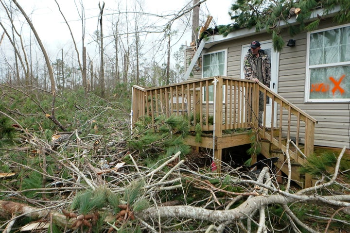 Luther Owensby looks out from the front porch of his storm-damaged home Friday, Jan. 13, 2023, in Jackson, Ga. Powerful storms spawned tornadoes across Georgia Thursday night.