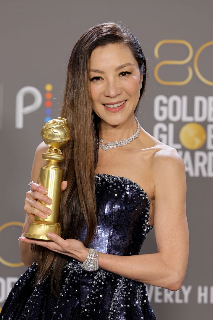 Michelle yeoh poses with the best actress in a motion picture – musical or comedy award for