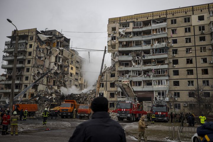 Firefighters conduct search and rescue operation in the rubbles of a destroyed residential building after a Russian missile strike in Dnipro, Ukraine, on January 15.