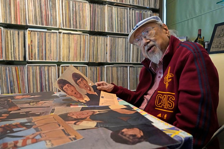 FILE - Ray Cordeiro, Hong Kong's oldest DJ shows the copies of his Beatles' autographs as the originals are kept with the lawyer, at his home in Hong Kong, Thursday, May 27, 2021. Cordeiro considers himself the luckiest radio DJ in the world. Cordeiro, who interviewed music acts including the Beatles during a six-decade career on Hong Kong radio that earned him the title of the world's longest-working disc jockey, died Friday, Jan. 13, 2023, his former employer announced. He was 98. (AP Photo/Kin Cheung, File)