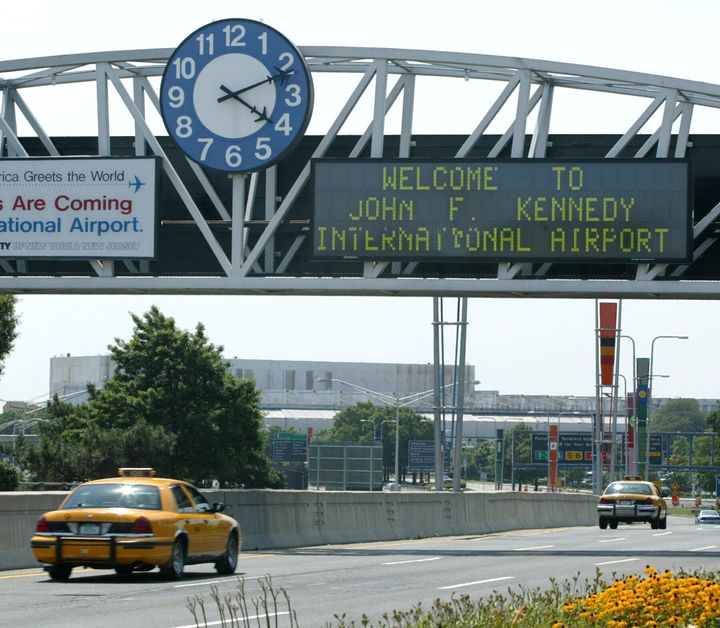 FILE - A clock at the entrance to JFK Airport in New York is pictured on Aug. 15, 2003. Officials are investigating a close call at the New York airport that happened Friday, Jan. 13, 2023, between a plane that was crossing a runway and another that was preparing for takeoff. (AP Photo/Stuart Ramson, File)