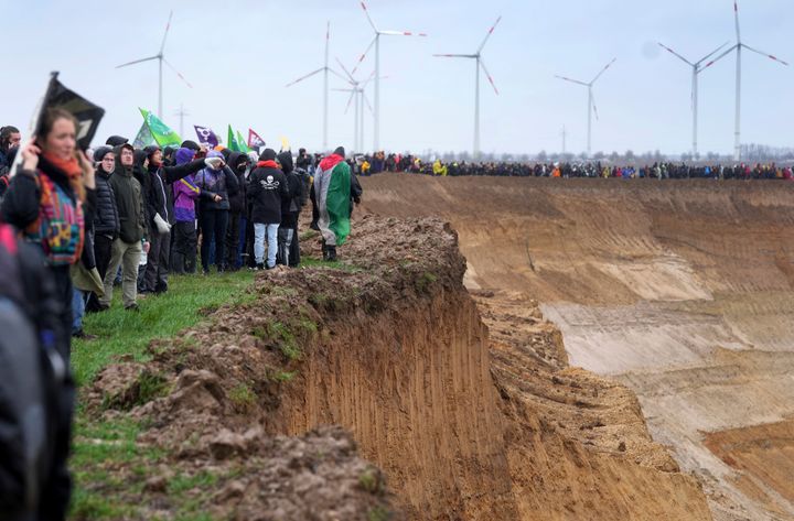 People attend a protest rally at the Garzweiler mine near the village Luetzerath in Erkelenz, Germany, Saturday, Jan. 14, 2023.