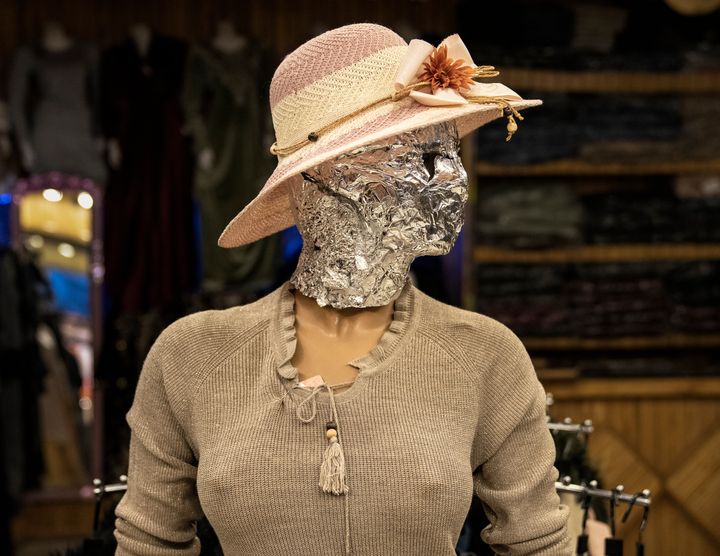 A mannequin's head is covered in foil in a woman dress shop in Kabul, Afghanistan.