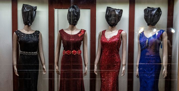 Faceless mannequins line up in a women's dress store shop in Kabul.