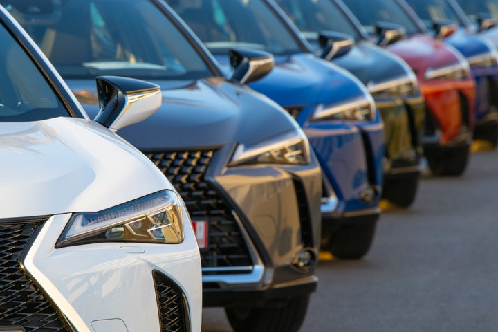 Sitges, Spain - 26th February, 2019: Lexus UX (Toyota Group) SUV vehicles in hybrid version parked on public parking before the drives. The UX model is the smallest crossover in the Lexus offer. Focus on a first car.