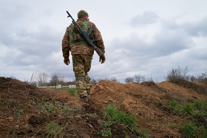 A Ukrainian soldier stands guard in a trench in Kherson, which is close to Crimea
