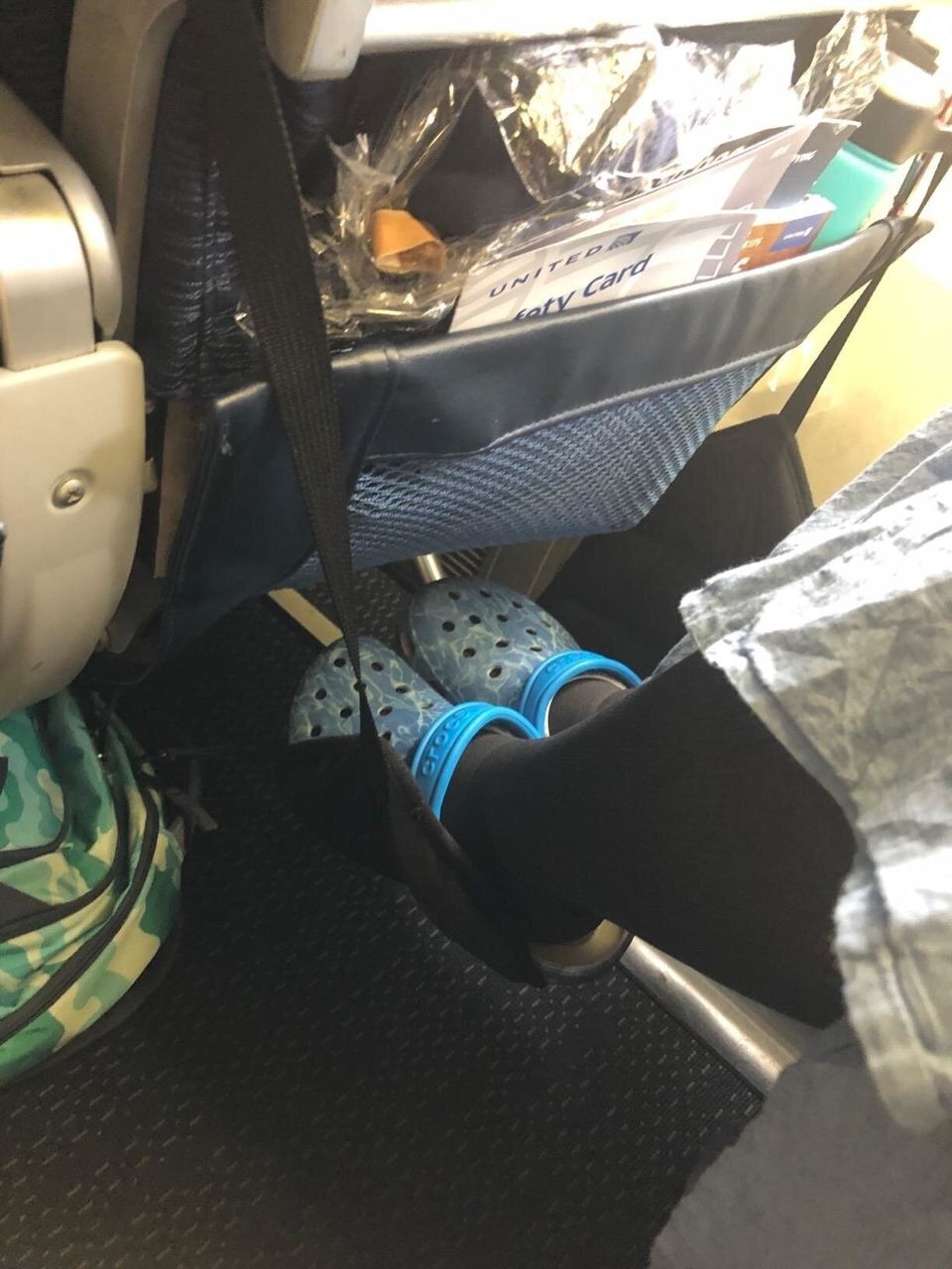 An airplane footrest that loops over your tray table