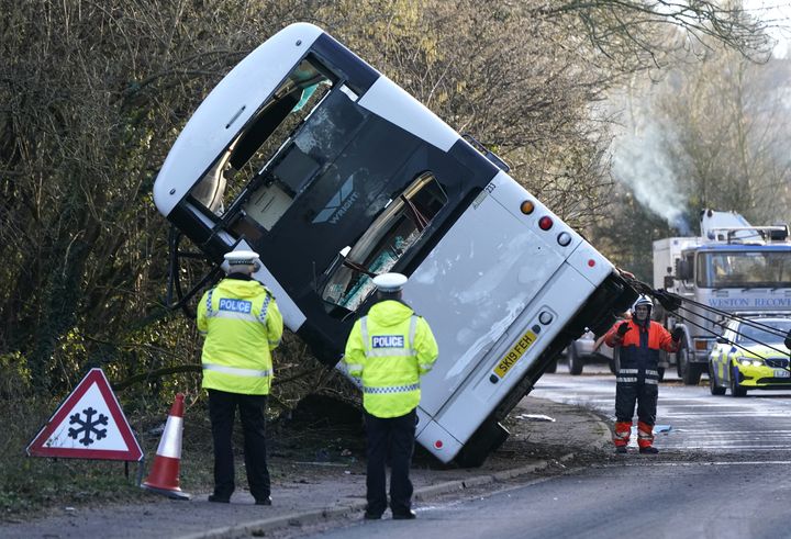 Police at the scene on the A39 Quantock Road in Bridgwater as a double-decker bus is righted by a recovery lorries after it overturned in a crash involving a motorcycle.