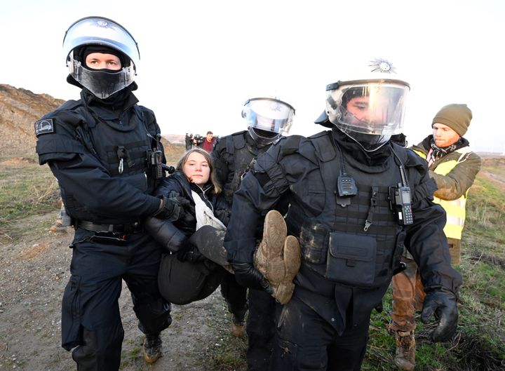 Police officers carry Swedish climate activist Greta Thunberg out of a group of protesters and activists and away from the edge of the Garzweiler II opencast lignite mine.